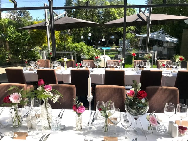Al fresco banquet setup with elegant floral decor for outdoor corporate and social events.