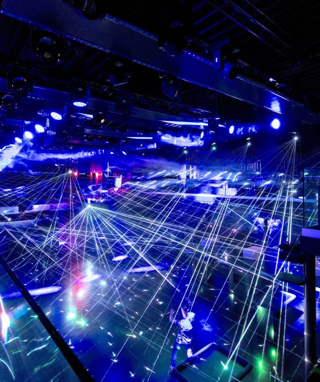 Event planner managing immersive laser and atmospheric lighting for a brand launch or gala event.