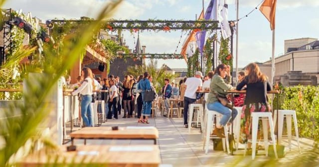 Bozar rooftop networking reception with high-top tables for casual business events.
