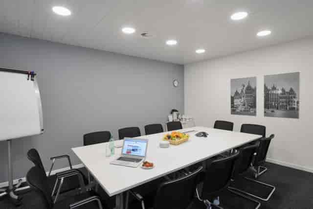 Boardroom meeting room with central table for team breakouts and corporate workshops.