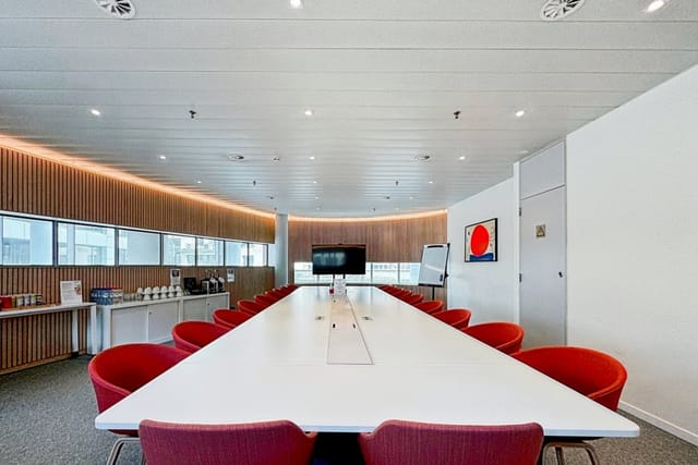 Modern boardroom at (re)space European Quarter with integrated AV for corporate events and meetings.