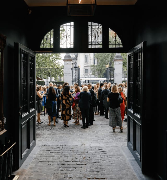 Outdoor networking reception at TheMerode lounge bar, elegant historic courtyard event.