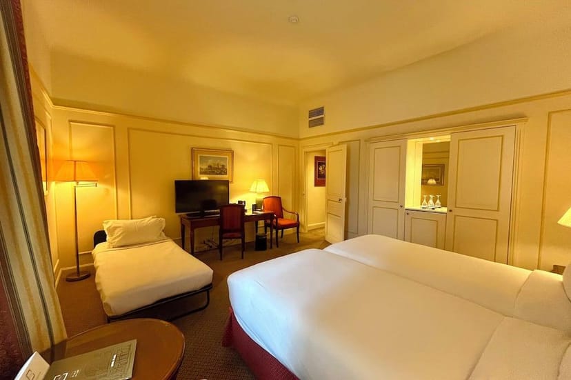 Triple-occupancy hotel room at Le Plaza for group travel and event lodging.