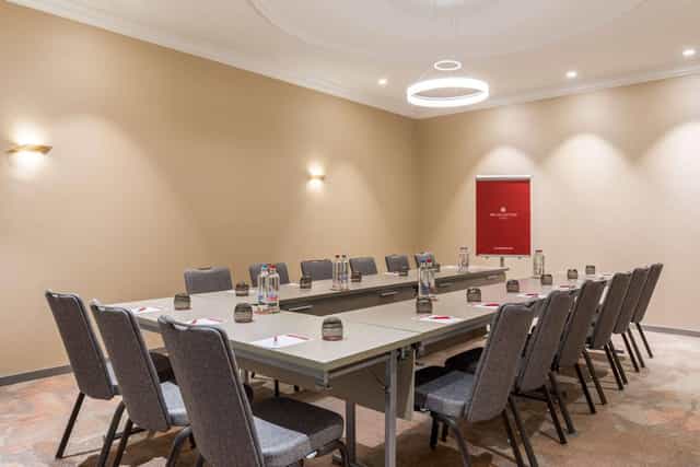 U-shape meeting room setup for corporate events and training at NH Collection Brussels.