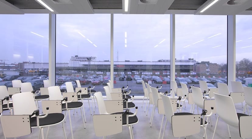 Modern auditorium with tablet-arm chairs for corporate training and workshop event rental.