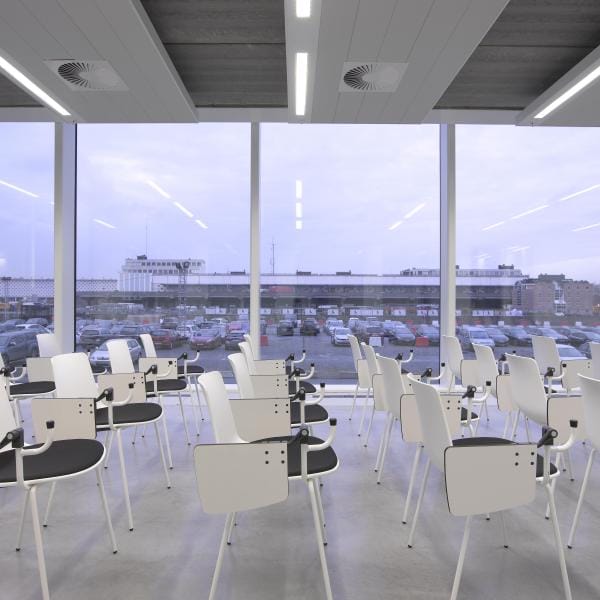 Theater-style training room with tablet arm chairs for corporate workshops and professional seminars.