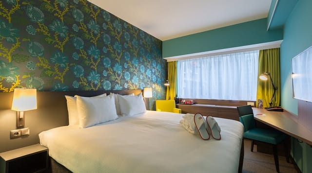 Modern guest room at Thon Hotel EU with workspace, ideal for business conference accommodation.