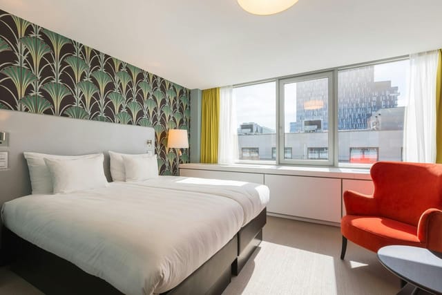 Thon Hotel EU conference guest room with twin beds for business event housing and productivity.