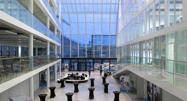 Eco-Dynamic Work Space: Modern high-ceilinged atrium for networking reception and corporate events.