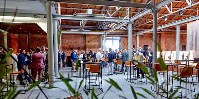 Modular Space networking event at Maison du Bois with industrial-chic high-top tables.