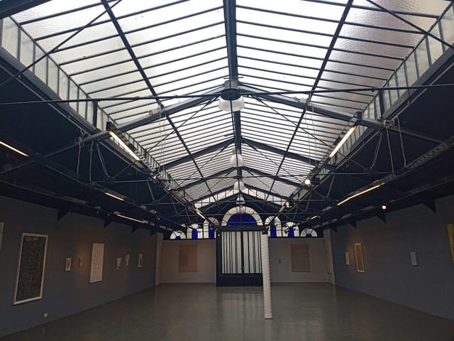 Glass roof at Galerie La Patinoire Royale Bach, industrial event venue for product launches.