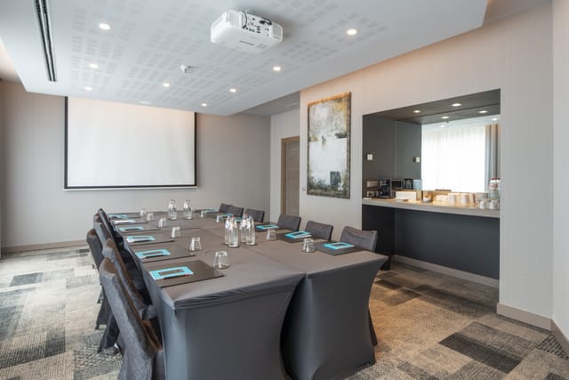 Konrad Adenauer boardroom with projector screen, ideal for professional meetings and presentations.