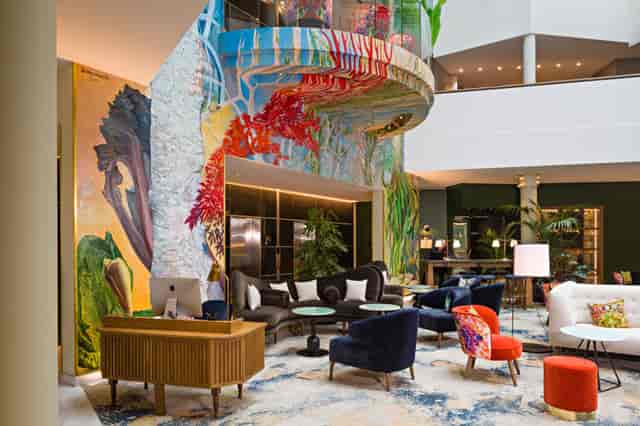 Jourdan Lounge hotel lobby with atrium mural for premium welcome receptions and corporate events.