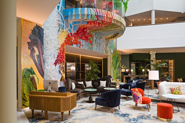 Jourdan Lounge hotel lobby with atrium mural for premium welcome receptions and corporate events.