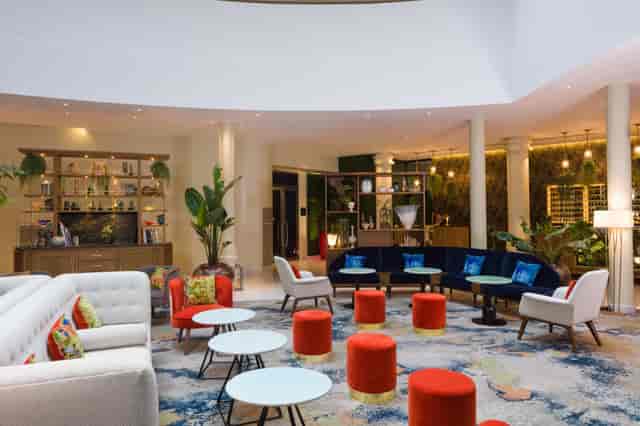 Jacques Delors in Sofitel Brussels hotel lobby lounge for professional networking and conferences.