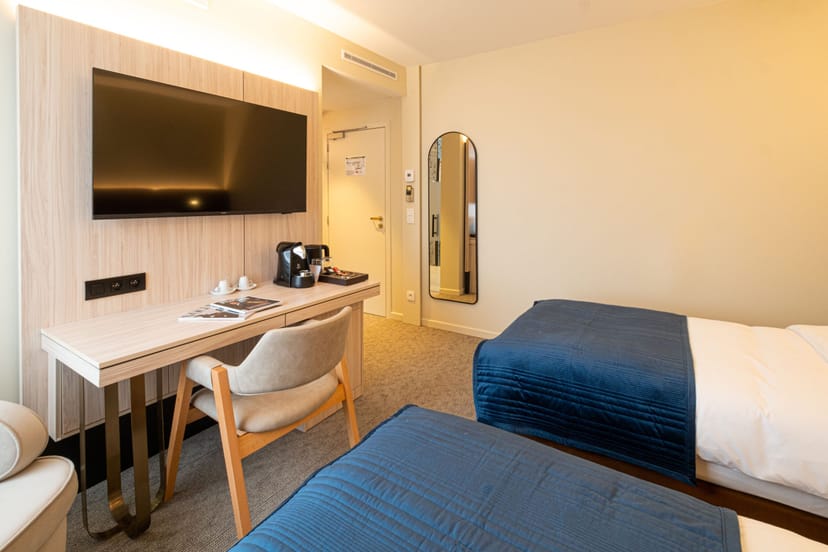 Twin guest room with ergonomic workstation at The Liman Hotel for business travel and conferences.
