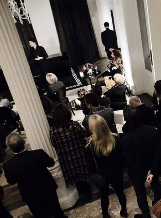 Lounge-style networking reception with floral cocktail tables in a luxury corporate event space.