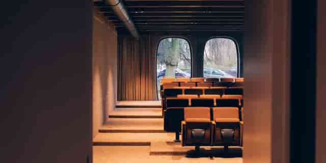 Tiered boardroom with natural light for executive briefings and corporate presentations.