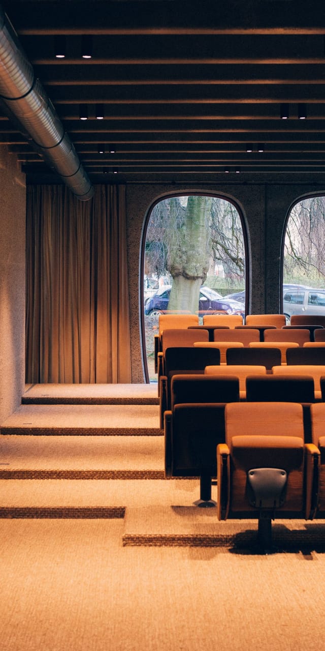 Auditorium with theater seating for corporate lectures and business workshops.