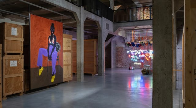 Industrial art gallery venue with shipping crates for pop-up exhibitions and experiential events.