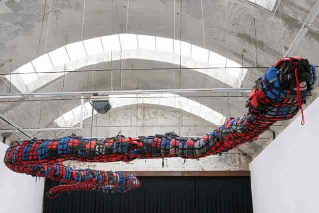 Suspended art installation in industrial museum venue for corporate gala or themed event.