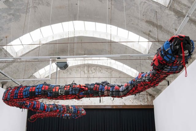 Suspended art installation in industrial museum venue for corporate gala or themed event.