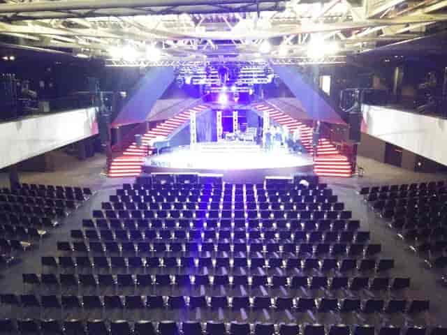 Plenary session at La Madeleine: Elevated stage with theater-style seating for corporate events.