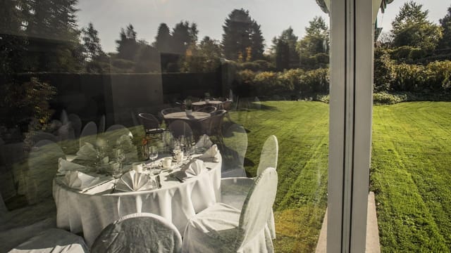 Formal garden venue setup at Salons de Romree with crisp linens for corporate events or weddings.