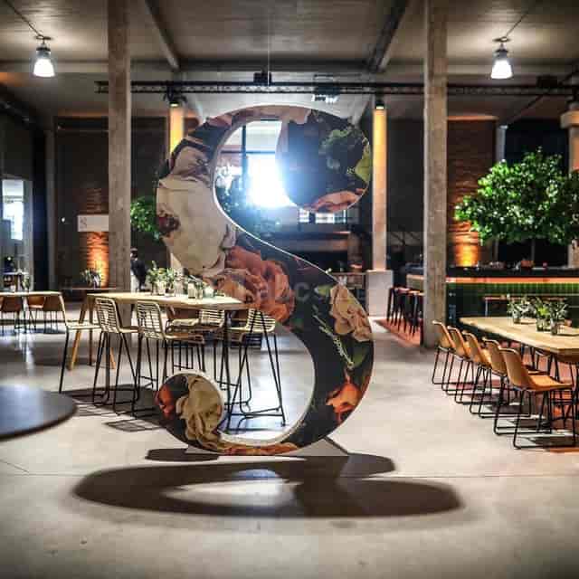 Oversized floral signage at Meudon Silo Brussels for corporate networking event.