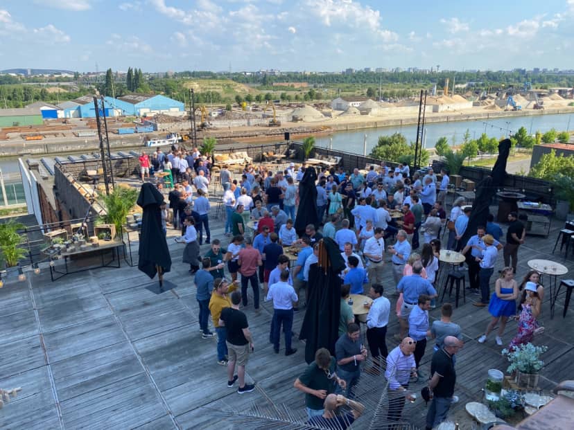 Industrial-chic rooftop reception in Silo Brussels with waterfront views for networking events.