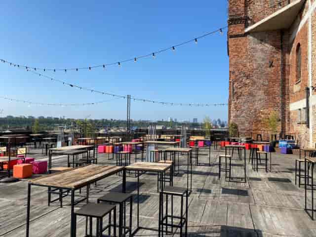 Industrial rooftop venue in Silo Brussels with string lighting for networking and cocktail events.