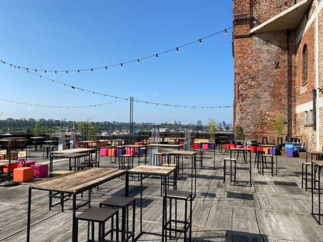 Industrial rooftop venue in Silo Brussels with string lighting for networking and cocktail events.