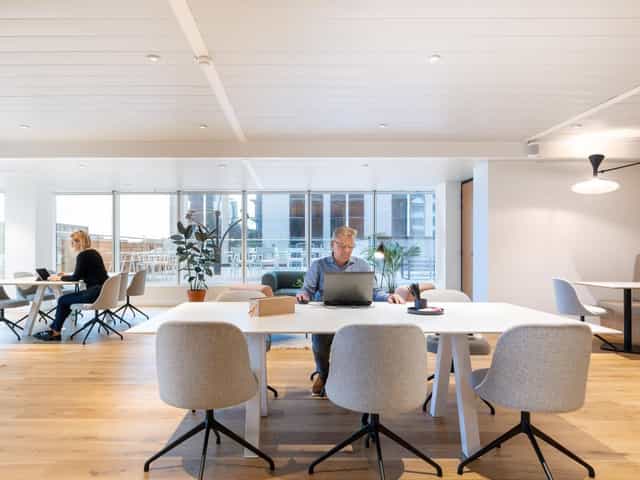 Modern coworking space with modular seating for professional remote work and business meetings.