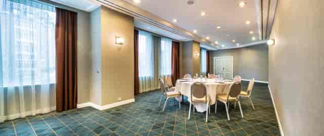 Bright Brussels conference center with round table setup for workshops and gatherings.
