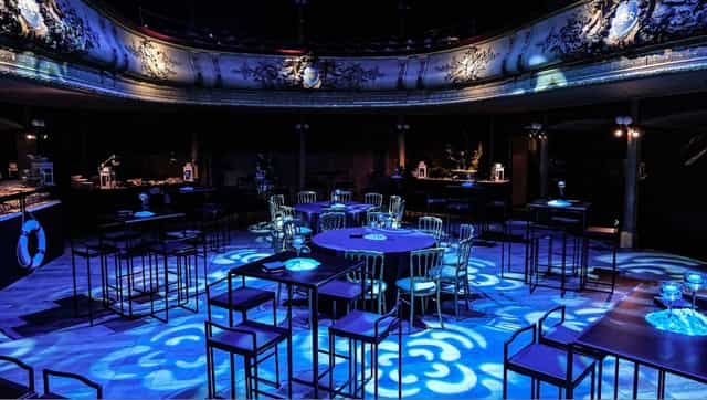 Salle des Clés event venue with moody lighting for evening receptions and corporate gala events.