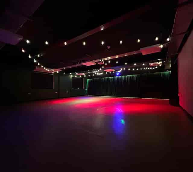 RockLab event space with industrial ceilings and festoon lighting for corporate or party rentals.