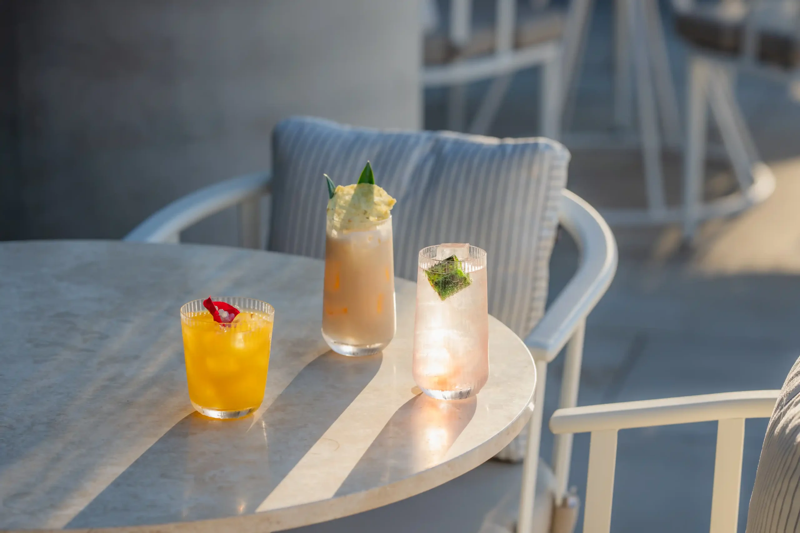 Stylish outdoor terrace with cocktails at HERA Restaurant for social gatherings.