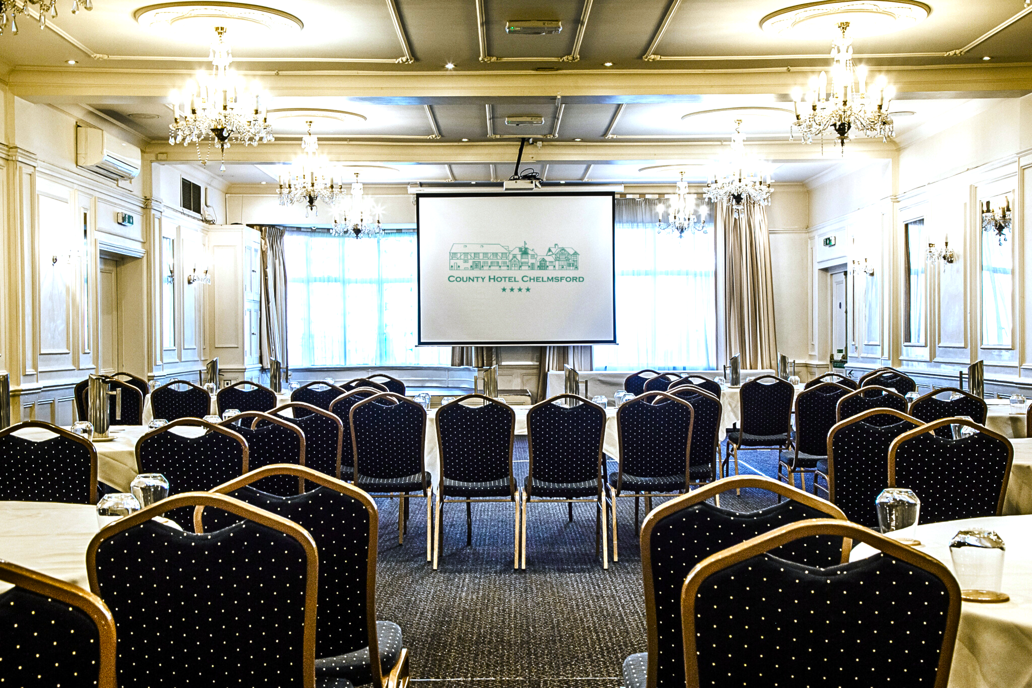Crystal Ballroom conference setup with rows of seating for business seminars or corporate events. - Banner
