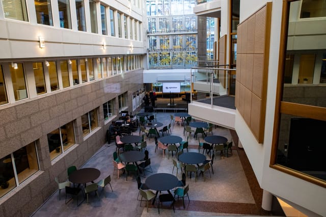 Corporate town hall setup in The Atrium at Epicenter Oslo, featuring tiered architectural seating.