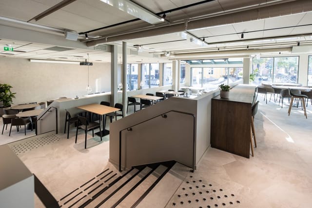Modern function room with hybrid breakout seating for business meetings and networking events.