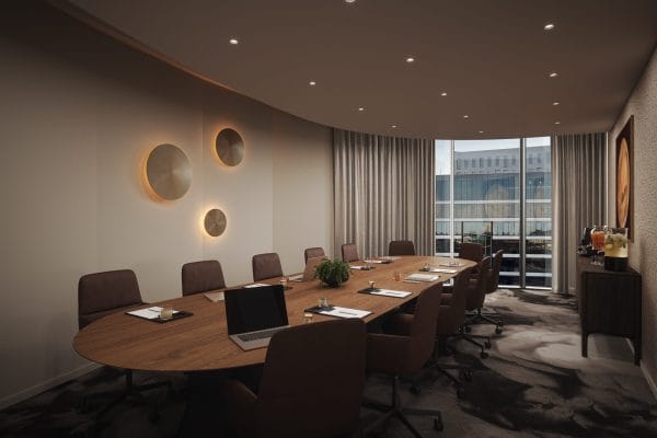 Executive boardroom for SIXA Conference strategy meeting with natural light and refreshment area.