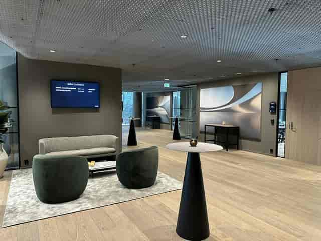 SIXA Conference lounge with networking seating and digital signage for professional event hosting.