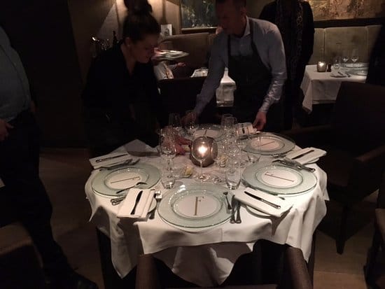 Fine dining staff setting tables at Spisestuen Feinschmecker for an elegant event or wedding.