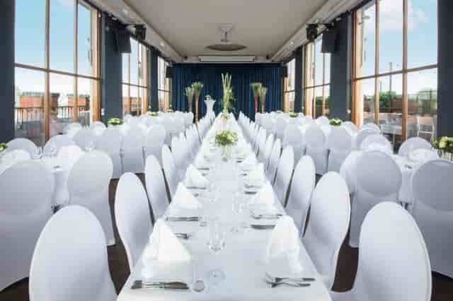 Banquet hall with floor-to-ceiling windows for professional weddings and corporate events.