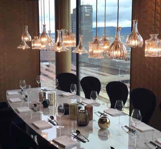 Luxury private dining at Nodee Sky: polished stone table for VIP meetings and executive events.