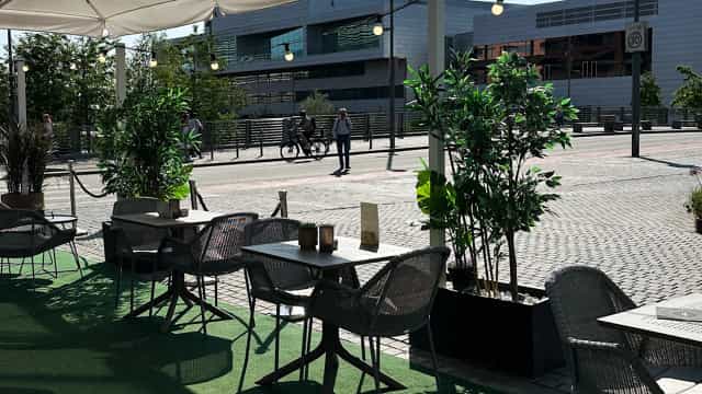 Outdoor networking area at Clarion Hotel Oslo with bistro tables and greenery for events.