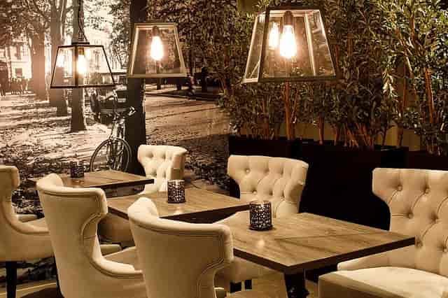 Saga Hotel Oslo lobby bar with tufted wingback chairs for boutique networking and corporate events.
