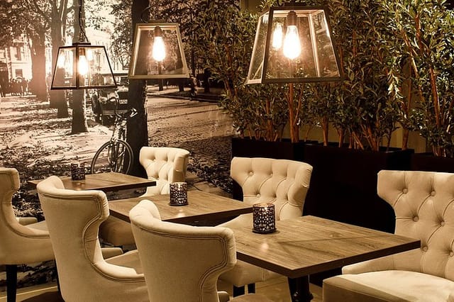 Saga Hotel Oslo lobby bar with tufted wingback chairs for boutique networking and corporate events.