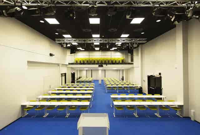 Classroom-style Thon Conference venue with industrial mezzanine for corporate events.
