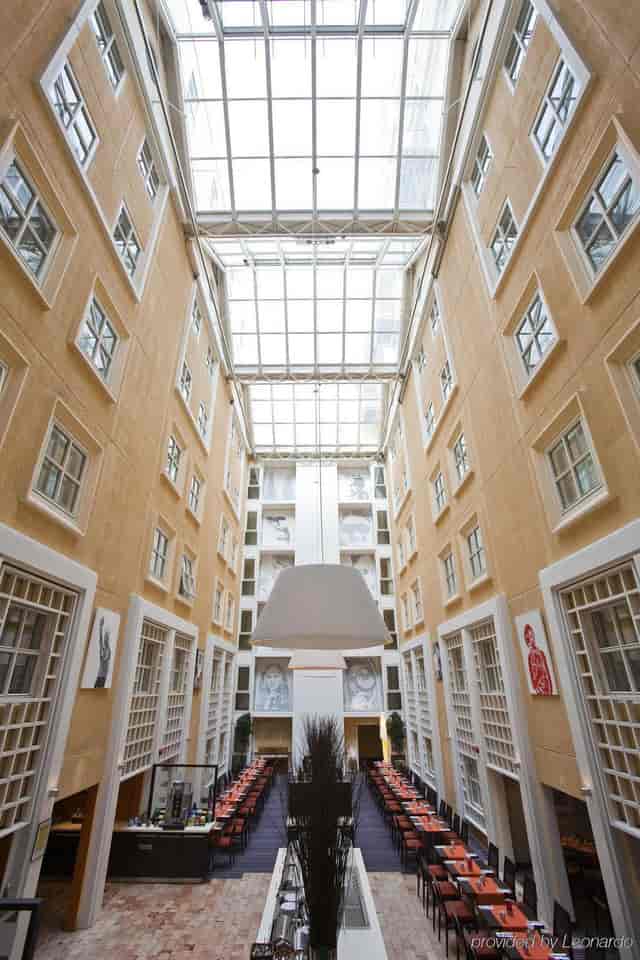 Scandic Victoria Oslo sunlit hotel atrium for corporate networking and registration events.